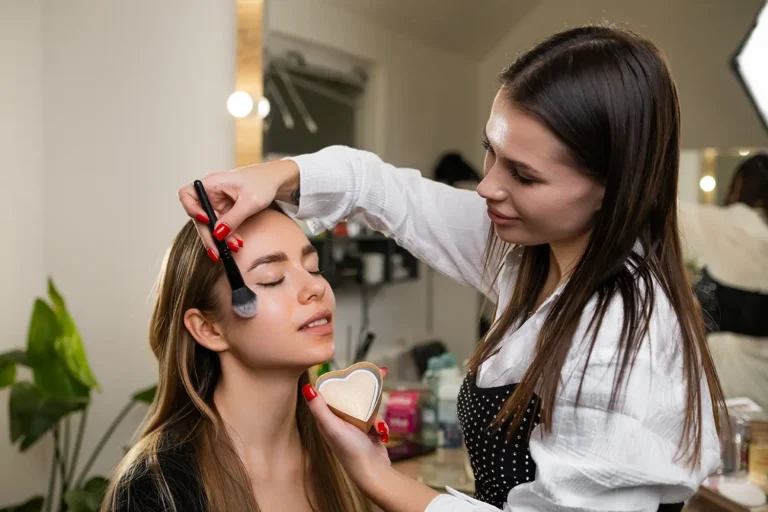 makeup-artist-does-makeup-apply-highlighter-young-woman copy