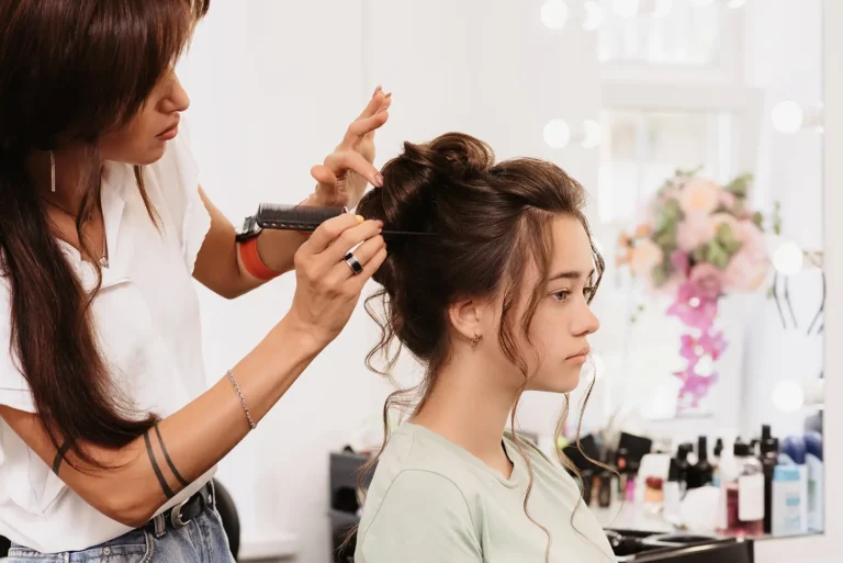 shooting-beauty-salon-hair-master-corrects-hairstyle-young-dark-haired-girl-with-help-hair-brush copy