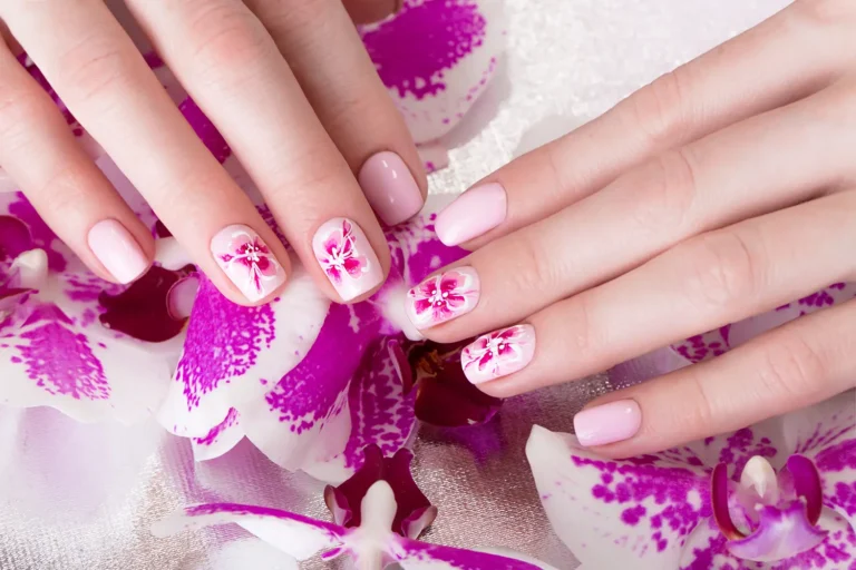 shot-beautiful-manicure-with-flowers-female-fingers-nails-design-closeup-picture-taken-studio-white-background copy